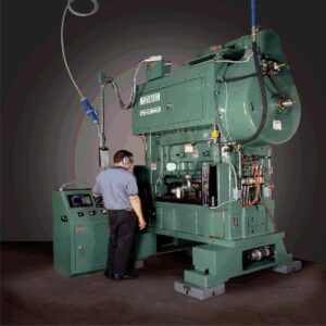 man operating large green metal stamping machine